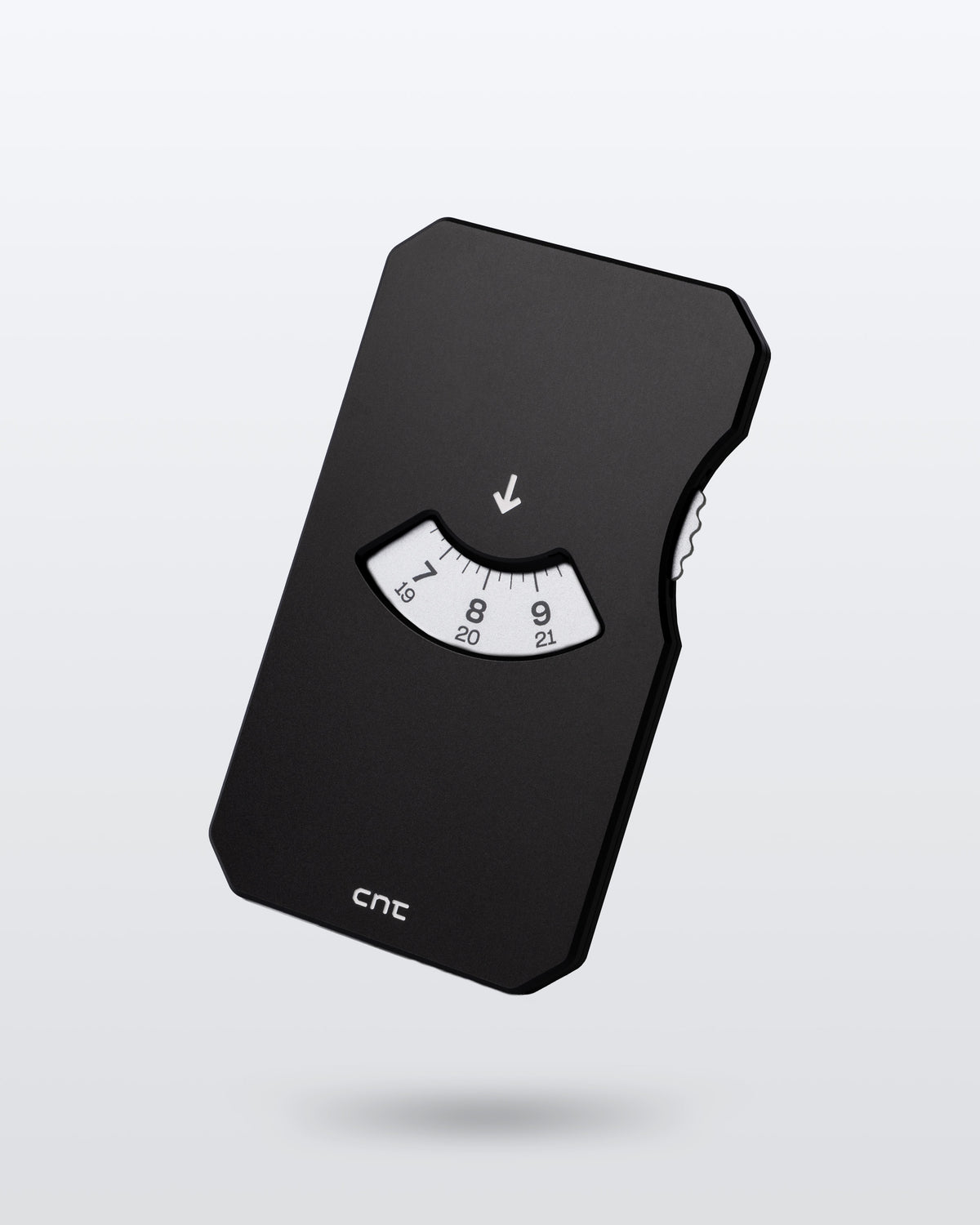 A black parking disc with silver facing disc, engraved cnt logo at the botom, floating against a grey background.